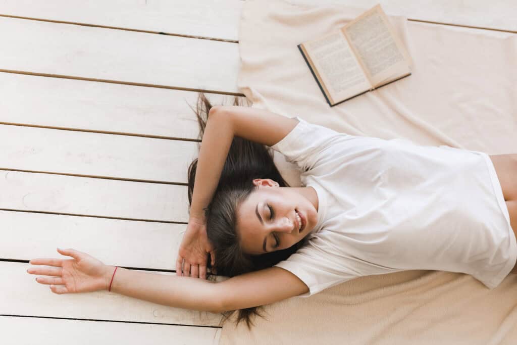 15 cheerful-woman-sleeping-near-book